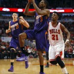 Phoenix Suns guard Brandon Knight (3) shoots past Chicago Bulls guard Jimmy Butler (21) during the second half of an NBA basketball game in Chicago, on Saturday, Feb. 21, 2015. The Bulls won the game 112-107. (AP Photo/Jeff Haynes)