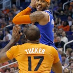  New York Knicks' Carmelo Anthony looks to pass as Phoenix Suns' P.J. Tucker (17) defends during the first half of an NBA basketball game, Friday, March 28, 2014, in Phoenix (AP Photo/Matt York)