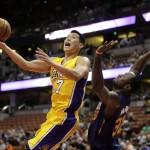 Los Angeles Lakers' Jeremy Lin, left, puts up a shot against Phoenix Suns' Earl Barron during the first half of a preseason NBA basketball game on Tuesday, Oct. 21, 2014, in Anaheim, Calif. (AP Photo/Jae C. Hong)