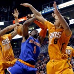  New York Knicks' Amare Stoudemire (1) has his shot blocked by Phoenix Suns' Markieff Morris, left, as Channing Frye (8) defends during the first half of an NBA basketball game, Friday, March 28, 2014, in Phoenix. (AP Photo/Matt York)