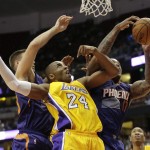 Phoenix Suns' P.J. Tucker, right, gets a rebound against Los Angeles Lakers' Kobe Bryant during the second half of a preseason NBA basketball game Tuesday, Oct. 21, 2014, in Anaheim, Calif. The Suns won 114-108 in overtime. (AP Photo/Jae C. Hong)