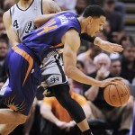Phoenix Suns forward Gerald Green, front, drives past San Antonio Spurs guard Danny Green during the first half of an NBA basketball game on Friday, April 11, 2014, in San Antonio. (AP Photo/Darren Abate)
