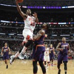 Chicago Bulls guard Jimmy Butler (21) goes in for a lay up past Phoenix Suns forward Markieff Morris (11) during the second half of an NBA basketball game in Chicago, on Saturday, Feb. 21, 2015. The Bulls won the game 112-107. (AP Photo/Jeff Haynes)