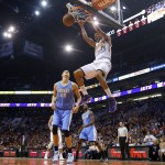 Phoenix Suns' Gerald Green (14) dunks over Denver Nuggets' Timofey Mozgov (25), of Russia, as Nuggets' Alonzo Gee (1) looks on during the second half of an NBA basketball game Wednesday, Nov. 26, 2014, in Phoenix. The Suns defeated the Nuggets 120-112. (AP Photo/Ross D. Franklin)
