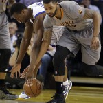 Phoenix Suns' Marcus Morris, right, and Golden State Warriors' Harrison Barnes chase the ball during the first half of an NBA basketball game Thursday, April 2, 2015, in Oakland, Calif. (AP Photo/Ben Margot)