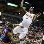 Milwaukee Bucks' Johnny O'Bryant III (3) is fouled as he goes up for a shot against Phoenix Suns' Markieff Morris during the first half of an NBA basketball game Tuesday, Jan. 6, 2015, in Milwaukee. (AP Photo/Morry Gash)