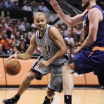 San Antonio Spurs guard Tony Parker, left, of France, drives around Phoenix Suns forward Miles Plumlee during the first half of an NBA basketball game on Friday, April 11, 2014, in San Antonio. (AP Photo/Darren Abate)
