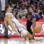 Phoenix Suns' Eric Bledsoe, right, is fouled by Los Angeles Clippers' Blake Griffin during the second half of an NBA basketball game Monday, Dec. 8, 2014, in Los Angeles. The Clippers won 121-120 in overtime. (AP Photo/Jae C. Hong)