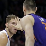 Los Angeles Clippers' Blake Griffin, left, is defended by Phoenix Suns' Alex Len, of Ukraine, during the first half of an NBA basketball game Monday, Dec. 8, 2014, in Los Angeles. (AP Photo/Jae C. Hong)