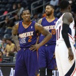Phoenix Suns guard Eric Bledsoe (2) and Phoenix Suns forward Marcus Morris (15) are shown in the closing seconds of their win over the Atlanta Hawks in an NBA basketball game Monday, March 24, 2014, in Atlanta. Phoenix defeated Atlanta 102-95. (AP Photo/Jason Getz)