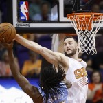 Phoenix Suns' Miles Plumlee, right, blocks the shot of Denver Nuggets' Kenneth Faried during the second half of an NBA basketball game Wednesday, Nov. 26, 2014, in Phoenix. The Suns defeated the Nuggets 120-112. (AP Photo/Ross D. Franklin)