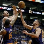 San Antonio Spurs forward Aron Baynes, top left, loses the ball as Phoenix Suns center Miles Plumlee, front right, and Markieff Morris (15) defend during the first half of an NBA preseason basketball game, Thursday, Oct. 16, 2014, in Phoenix. (AP Photo/Matt York)