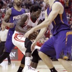 Houston Rockets' Patrick Beverley, center, is caught between Phoenix Suns Marcus Morris, left, and Goran Dragic in the second half of an NBA basketball game Saturday, Dec. 6, 2014, in Houston. The Rockets won 100-95. (AP Photo/Pat Sullivan)