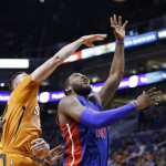 Detroit Pistons' Greg Monroe, right, gets past Phoenix Suns' Miles Plumlee, left, for a shot during the first half of an NBA basketball game Friday, Dec. 12, 2014, in Phoenix. (AP Photo/Ross D. Franklin)
