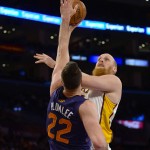  Los Angeles Lakers center Chris Kaman. back right, drives on Phoenix Suns center Miles Plumlee (22) for a basket in the first half of an NBA basketball game, Sunday, March 30, 2014, in Los Angeles.(AP Photo/Gus Ruelas)