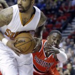 Phoenix Suns forward Markieff Morris, left, looks to pass as Portland Trail Blazers guard Wesley Matthews reaches in from behind during the first half of an NBA basketball game in Portland, Ore., Thursday, Feb. 5, 2015. (AP Photo/Don Ryan)