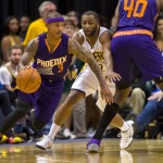 Phoenix Sun's Isaiah Thomas (3) works the ball around the court with Indiana Pacer's A.J. Price (12) during the second half of an NBA basketball game, Saturday, Nov. 22, 2014, in Indianapolis. The Suns defeated the Pacers 106-83. (AP Photo/Doug McSchooler)