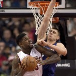  Toronto Raptors forward Amir Johnson, left, drives to the hoop against Phoenix Suns center Alex Len during the first half of an NBA basketball game in Toronto on Sunday, March 16, 2014. (AP Photo/The Canadian Press, Frank Gunn)