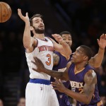 New York Knicks' Jose Calderon (3) loses control of the ball as Phoenix Suns' Eric Bledsoe (2) defends during the first half of an NBA basketball game, Saturday, Dec. 20, 2014, in New York. (AP Photo/Frank Franklin II)