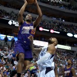 Phoenix Suns forward T.J. Warren (12) drives to the basket against Dallas Mavericks Tyson Chandler (6) in the first half of the NBA basketball game in Dallas on Wednesday, April 8, 2015. (AP Photo/Brad Loper)