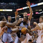  Memphis Grizzlies' Tony Allen, center, is pressured by Phoenix Suns' Eric Bledsoe, left, Miles Plumlee, rear, and Goran Dragic, of Slovenia, during the first half of an NBA basketball game, Monday, April 14, 2014, in Phoenix. (AP Photo/Matt York)