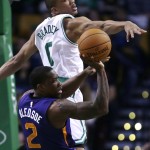 Boston Celtics guard Avery Bradley (0) tries to block a pass by Phoenix Suns guard Eric Bledsoe (2) during the first quarter of an NBA basketball game in Boston, Monday, Nov. 17, 2014. (AP Photo/Charles Krupa)
