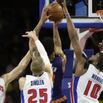 Phoenix Suns guard Gerald Green makes a basket while defended by Detroit Pistons forwards Jonas Jerebko (33), Kyle Singler (25) and Greg Monroe (10) during the first half of an NBA basketball game in Auburn Hills, Mich., Wednesday, Nov. 19, 2014. (AP Photo/Carlos Osorio)