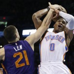 Oklahoma City Thunder guard Russell Westbrook (0) is fouled by Phoenix Suns center Alex Len (21) in the third quarter of an NBA basketball game in Oklahoma City, Sunday, Dec. 14, 2014. Oklahoma City won 112-88. (AP Photo/Sue Ogrocki)