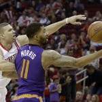 Houston Rockets' Francisco Garcia, left, reaches for the bobbled ball by Phoenix Suns' Markieff Morris (11) in the first half of an NBA basketball game Saturday, Dec. 6, 2014, in Houston. (AP Photo/Pat Sullivan)