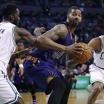  Phoenix Suns forward Markieff Morris, center, sets to drive between Boston Celtics forward Jeff Green (8) and guard Avery Bradley (0) during the second half of an NBA basketball game in Boston, Monday, Nov. 17, 2014. Morris had 30 points as the Suns defeated the Celtics 118-114. (AP Photo/Charles Krupa)