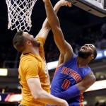 Detroit Pistons' Andre Drummond (0) gets his shot blocked by Phoenix Suns' Miles Plumlee, left, during the first half of an NBA basketball game Friday, Dec. 12, 2014, in Phoenix. (AP Photo/Ross D. Franklin)
