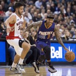 Phoenix Suns' Isaiah Thomas, right, drives past Toronto Raptors' Greivis Vasquez during the second half of an NBA basketball game in Toronto on Monday, Nov. 24, 2014. (AP Photo/The Canadian Press, Darren Calabrese)