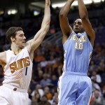 Denver Nuggets' Arron Afflalo (10) shoots over Phoenix Suns' Goran Dragic (1), of Slovenia, during the first half of an NBA basketball game Wednesday, Nov. 26, 2014, in Phoenix. (AP Photo/Ross D. Franklin)