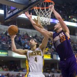 Indiana Pacer's Luis Scola (4) and Phoenix Sun's Miles Plumlee (22) battle for a rebound during the first half of an NBA basketball game, Saturday, Nov. 22, 2014, in Indianapolis. (AP Photo/Doug McSchooler)