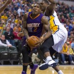 Phoenix Sun's Eric Bledsoe (2) breaks into the paint around the defense of Indiana Pacer's Ian Mahinmi (28) during the first half of an NBA basketball game, Saturday, Nov. 22, 2014, in Indianapolis. (AP Photo/Doug McSchooler)