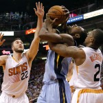  Memphis Grizzlies' Tony Allen, center, is fouled by Phoenix Suns' Eric Bledsoe (2) as Miles Plumlee (22) defends during the first half of an NBA basketball game, Monday, April 14, 2014, in Phoenix. (AP Photo/Matt York)