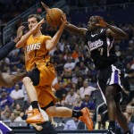Phoenix Suns guard Goran Dragic (1), of Slovenia, looks to pass as Sacramento Kings guard Darren Collison, right, defends during the second half of an NBA basketball game, Friday, Nov. 7, 2014, in Phoenix. The Kings won 114-112 in double overtime. (AP Photo/Matt York)