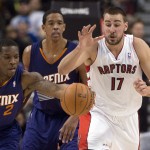  Toronto Raptors center Jonas Valanciunas (17) tries to chase down a loose ball against Phoenix Suns guard Eric Bledsoe (2) during the first half of an NBA basketball game in Toronto on Sunday, March 16, 2014. (AP Photo/The Canadian Press, Frank Gunn)