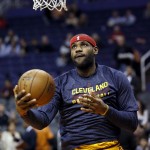 Cleveland Cavaliers' LeBron James warms up prior to an NBA basketball game against the Phoenix Suns, Tuesday, Jan. 13, 2015, in Phoenix. (AP Photo/Matt York)