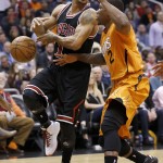 Phoenix Suns' Eric Bledsoe (2) strips the ball from Chicago Bulls' Derrick Rose (1) during the first half of an NBA basketball game Friday, Jan. 30, 2015, in Phoenix. (AP Photo/Ross D. Franklin)