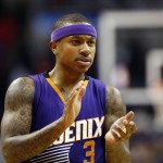 Phoenix Suns guard Isaiah Thomas applauds on the court late in the second half of an NBA basketball game against the Washington Wizards, Sunday, Dec. 21, 2014, in Washington. The Suns won 104-92. (AP Photo/Alex Brandon)