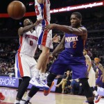 Phoenix Suns guard Eric Bledsoe (2) passes the ball around the defense of Detroit Pistons forward Jonas Jerebko, center, and center Andre Drummond (0), during the second half of an NBA basketball game in Auburn Hills, Mich., Wednesday, Nov. 19, 2014. (AP Photo/Carlos Osorio)