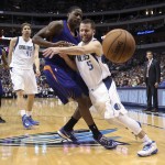 Dallas Mavericks guard J.J. Barea (5) loses the ball after colliding with Phoenix Suns' Archie Goodwin during the second half of an NBA basketball game in Dallas on Wednesday, April 8, 2015. Dallas won 107-104. (AP Photo/Brad Loper)