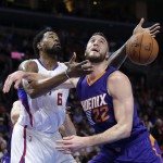 Los Angeles Clippers' DeAndre Jordan, left, and Phoenix Suns' Miles Plumlee fight for a rebound during the first half of an NBA basketball game Monday, Dec. 8, 2014, in Los Angeles. (AP Photo/Jae C. Hong)