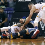 Memphis Grizzlies center Marc Gasol, center, scrambles for the ball with Phoenix Suns' Miles Plumlee, right, and Eric Bledsoe during the first half of an NBA basketball game, Wednesday, Nov. 5, 2014, in Phoenix. (AP Photo/Matt York)