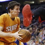 Phoenix Suns' Goran Dragic, of Slovenia, gets kicked in the head by Philadelphia 76ers' Tony Wroten as he stops with the ball before shooting during the second half of an NBA basketball game Friday, Jan. 2, 2015, in Phoenix. The Suns defeated the 76ers 112-96. (AP Photo/Ross D. Franklin)
