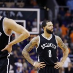 In the closing moments Brooklyn Nets' Bojan Bogdanovic (44), of Croatia, and Deron Williams (8) pace on the court during the second half of an NBA basketball game loss against the Phoenix Suns Wednesday, Nov. 12, 2014, in Phoenix. The Suns defeated the Nets 112-104. (AP Photo/Ross D. Franklin)