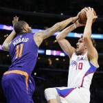Phoenix Suns' Markieff Morris, left, blocks a shot by Los Angeles Clippers' Spencer Hawes, right, during the first half of an NBA basketball game Saturday, Nov. 15, 2014, in Los Angeles. (AP Photo/Danny Moloshok)