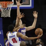 Detroit Pistons guard Spencer Dinwiddie (8) shoots over Phoenix Suns center Alex Len of Ukraine during the second half of an NBA basketball game in Auburn Hills, Mich., Wednesday, Nov. 19, 2014. (AP Photo/Carlos Osorio)