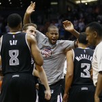 Sacramento Kings center DeMarcus Cousins, center, celebrates with teammates Rudy Gay (8) and Ray McCallum (3) after an NBA basketball game Friday, Nov. 7, 2014, in Phoenix against the Phoenix Suns. The Kings won 114-112 in double overtime. (AP Photo/Matt York)